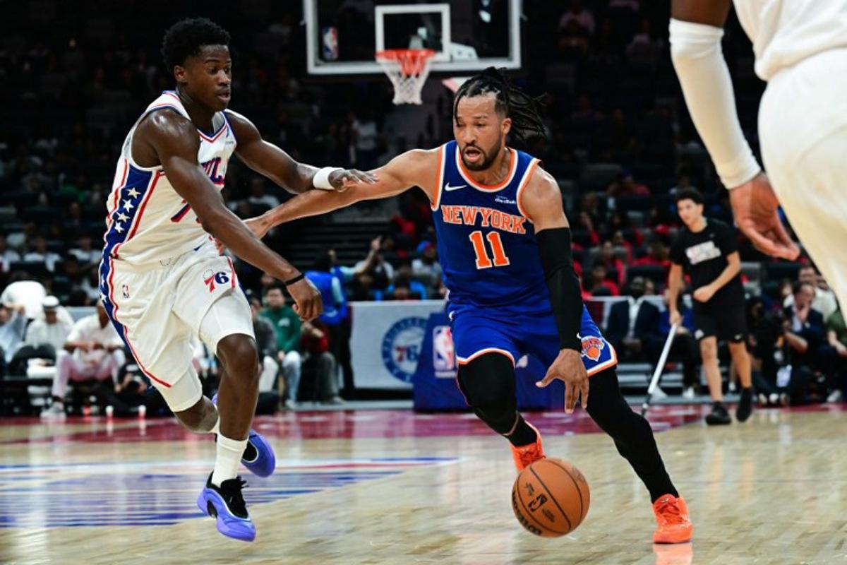 New York Knicks' #11 Jalen Brunson dribbles against Philadelphia 76ers' #77 VJ Edgecombe during the NBA basketball game between the New York Knicks and the Philadelphia 76ers at the Etihad Arena in Abu Dhabi on October 2, 2025. Giuseppe CACACE / AFP