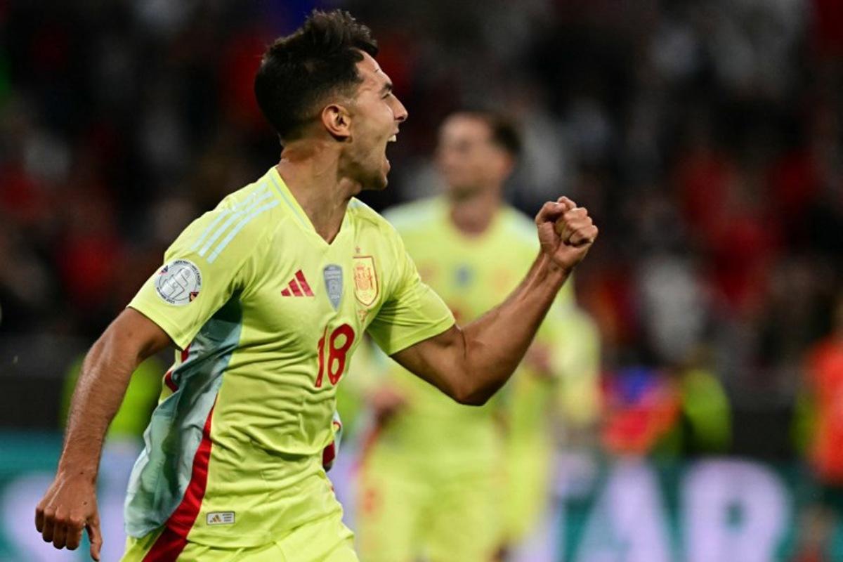 Spain's midfielder #18 Martin Zubimendi celebrates scoring the opening goal with his teammates during the UEFA Nations League final football match between Portugal and Spain in Munich, southern Germany on June 8, 2025. Tobias SCHWARZ / AFP