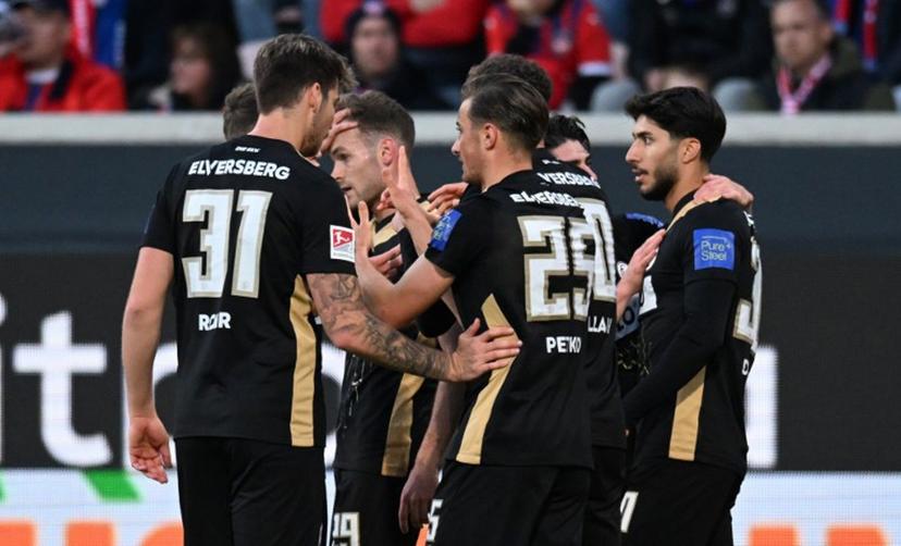 Elversberg's German midfielder #25 Lukas Petkov (R) celebrates with teammates scoring the opening goal during the German Bundesliga relegation first-leg football match between FC Heidenheim and SV Elversberg in Heidenheim on May 22, 2025. THOMAS KIENZLE / AFP
