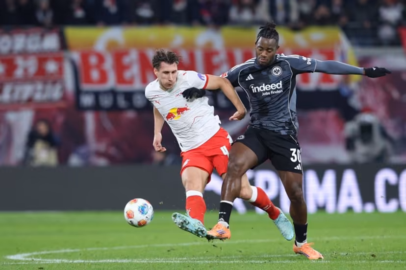 Leipzig's Hungarian defender #04 Willi Orban (L) and Frankfurt's Belgian forward #30 Michy Batshuayi vie for the ball during the German first division Bundesliga football match between RB Leipzig and Eintracht Frankfurt in Leipzig, eastern Germany, on December 6, 2025. Ronny HARTMANN / AFP