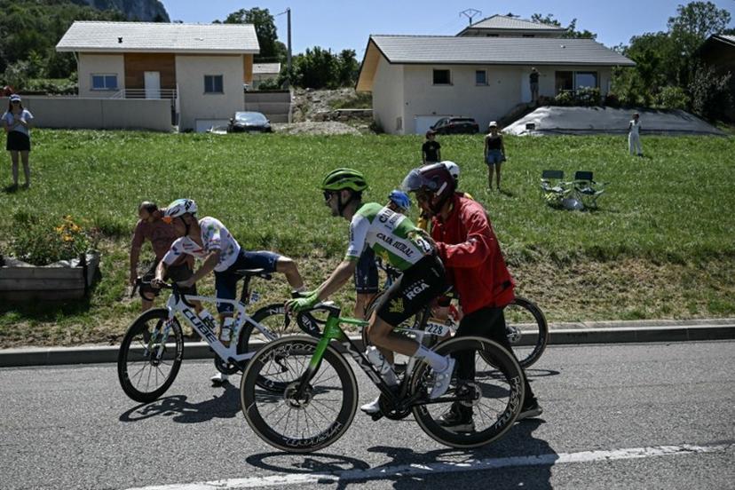 TotalEnergies team's French rider Alexandre Delettre and Caja Rural - Seguros RGA team's Spanish rider Jose Felix Parra receive assistance after a crash during the 17th stage of the 113th edition of the Tour de France cycling race, 174,7 km between Chambéry and Voiron in the French Alps, on July 22, 2026. Loic VENANCE / AFP