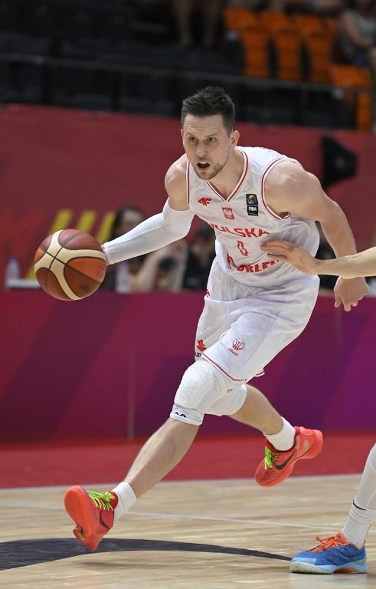 Poland's forward #09 Mateusz Ponitka controls the ball during the 2024 FIBA Olympic Qualifying Tournament basketball match between Poland and Finland in Valencia, on July 4, 2024. JOSE JORDAN / AFP