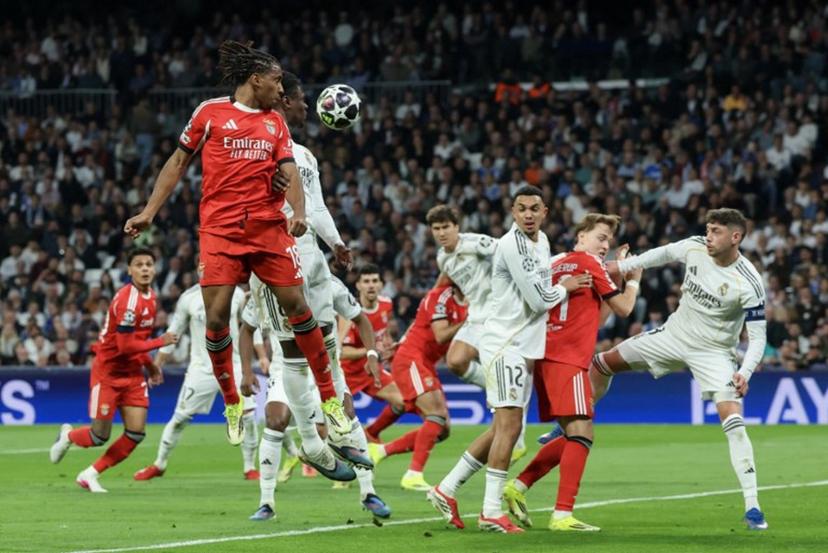 SL Benfica's Luxembourgish midfielder #18 Leandro Barreiro (L) goes for a header with Real Madrid's French midfielder #06 Eduardo Camavinga during the UEFA Champions League knockout round play-off second leg football match between Real Madrid CF and SL Benfica at Santiago Bernabeu Stadium in Madrid on February 25, 2026. Pierre-Philippe MARCOU / AFP