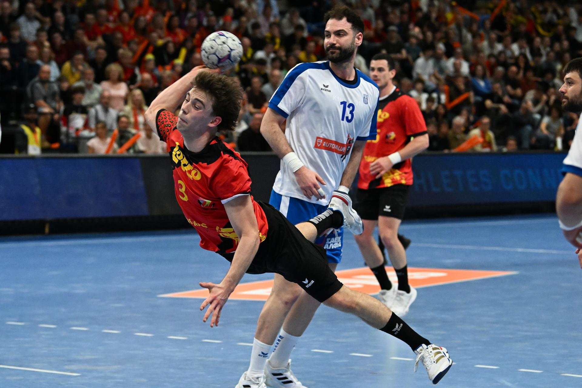 Belgium's Dree Riske and Greek Stefanos Michalidis pictured in action during a handball game between Belgian national team 'Red Wolves' and Greece, Saturday 21 March 2026 in Hasselt, fase 2 the qualifications for the men's 2027 World Championship. BELGA PHOTO JILL DELSAUX