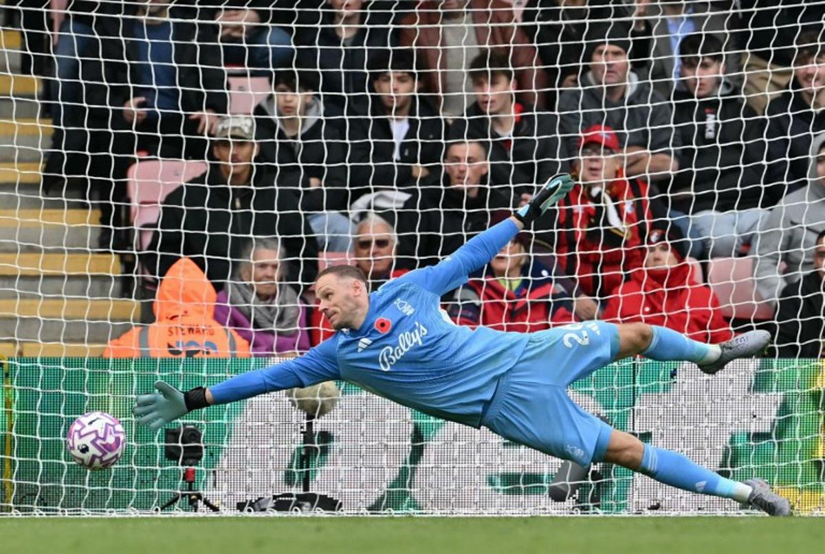 Nottingham Forest's Belgian goalkeeper #26 Matz Sels dives but can't get down quick enough to stop the shot by Bournemouth's French striker #22 Eli Junior Kroupi for Bournemouth's second goal 2-0 during the English Premier League football match between Bournemouth and Nottingham Forest at the Vitality Stadium in Bournemouth, southern England on October 26, 2025. Glyn KIRK / AFP
