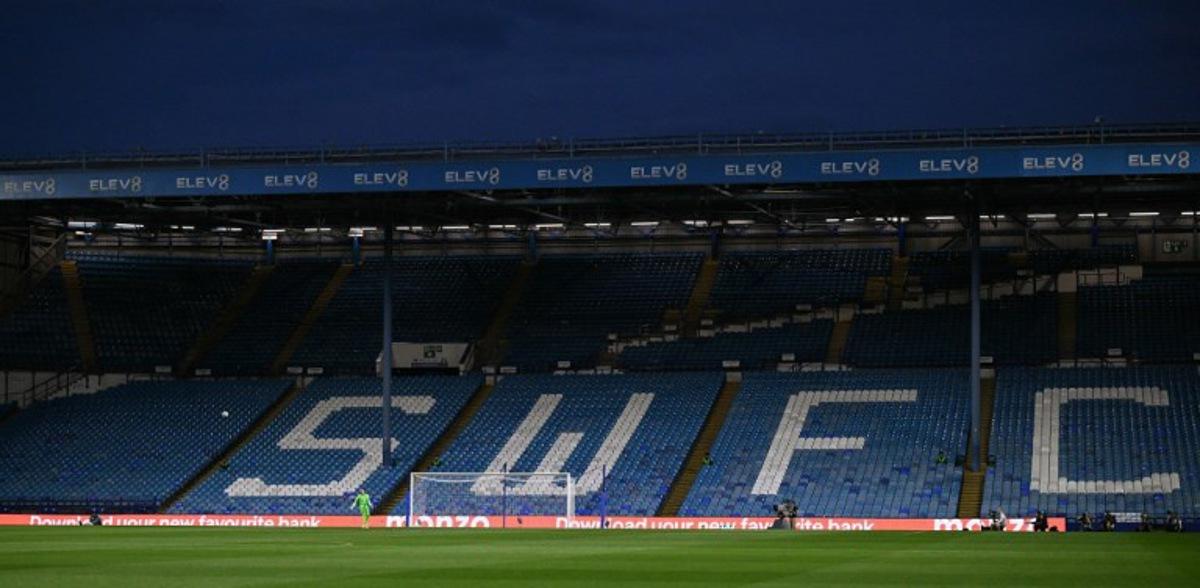 Sheffield Wednesday's US goalkeeper #24 Ethan Horvath takes a kick against empty seats due to a protest against Sheffield Wednesday's Thai owner Dejphon Chansiri during the English League Cup second round football match between Sheffield Wednesday and Leeds United at The Hillsborough Stadium in Sheffield, northern England on August 26, 2025. Oli SCARFF / AFP