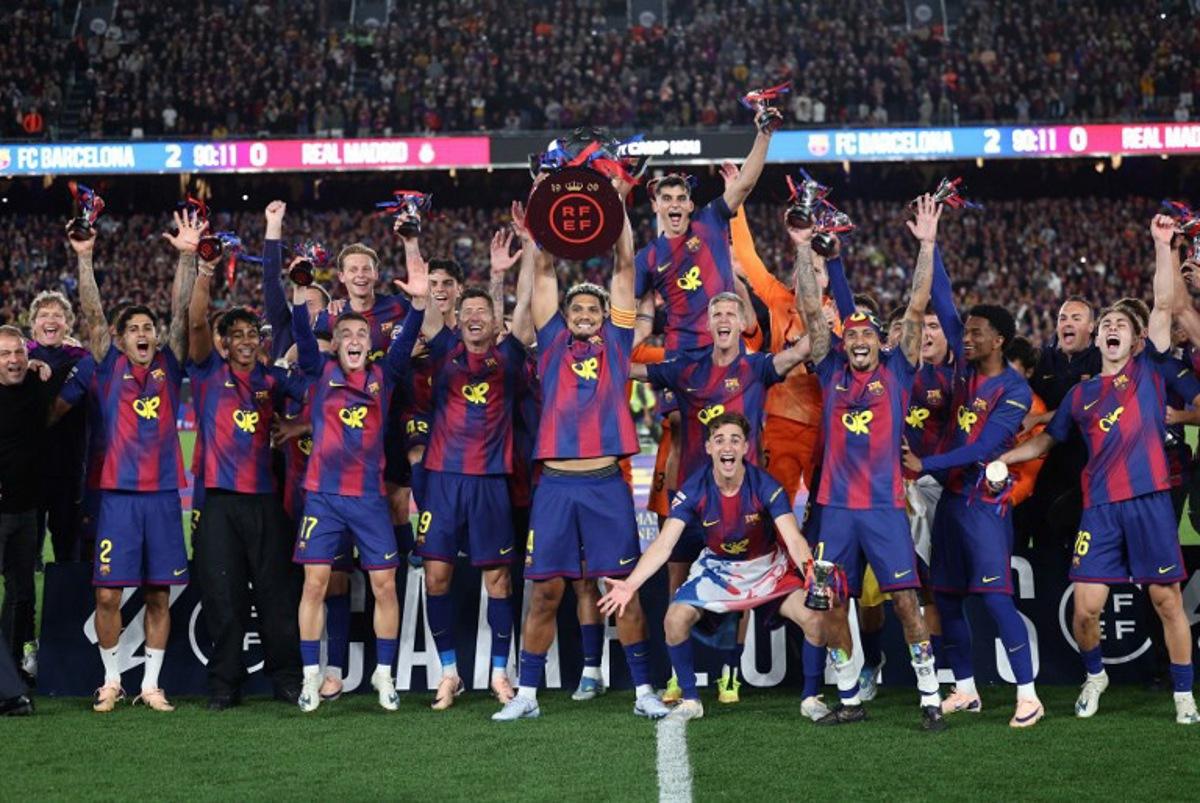 Barcelona's team celebrates winning the 2025-2026 Spanish League after the Spanish league football match between FC Barcelona and Real Madrid CF at Camp Nou Stadium in Barcelona on May 10, 2026. Josep LAGO / AFP