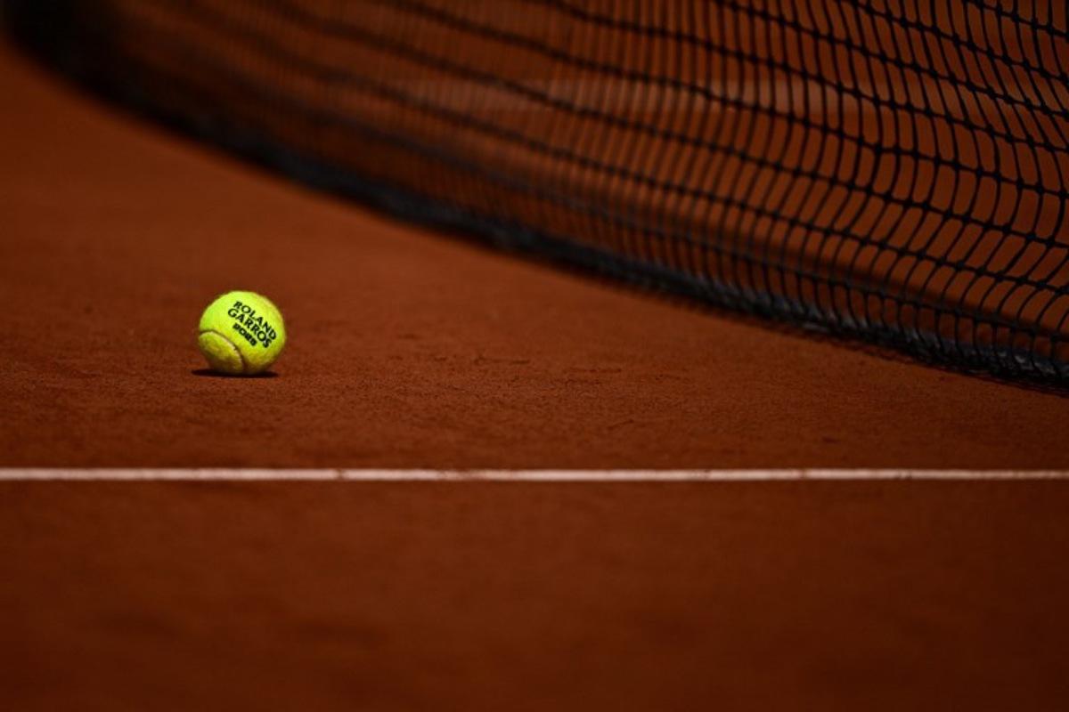 this photograph shows a tennis ball on a clay court during the French Open tennis tournament on day 10 at the Roland-Garros Complex in Paris on June 3, 2025. JULIEN DE ROSA / AFP