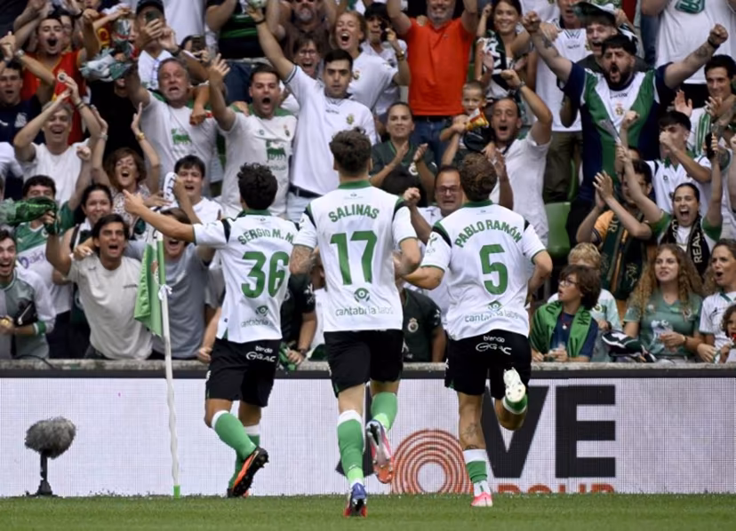 Racing Santander's Spanish midfielder #36 Sergio Martinez Montero celebrates with supporters scoring his team's second goal during the Spanish league football match between Racing Santander and Villarreal in El Sardinero stadium in Santander on August 16, 2026. ANDER GILLENEA / AFP