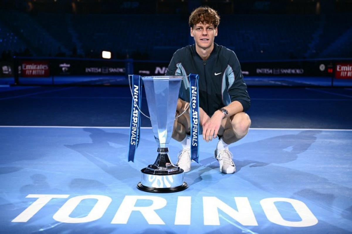 Italy's Jannik Sinner poses with the trophy after winning the final against USA's Taylor Fritz at the ATP Finals tennis tournament in Turin on November 17, 2024. Marco BERTORELLO / AFP