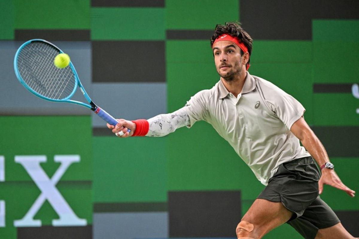 Italy's Lorenzo Musetti hits a return to China's Yi Zhou during their men's singles match at the Shanghai Masters tennis tournament in Shanghai on October 9, 2026. Hector RETAMAL / AFP