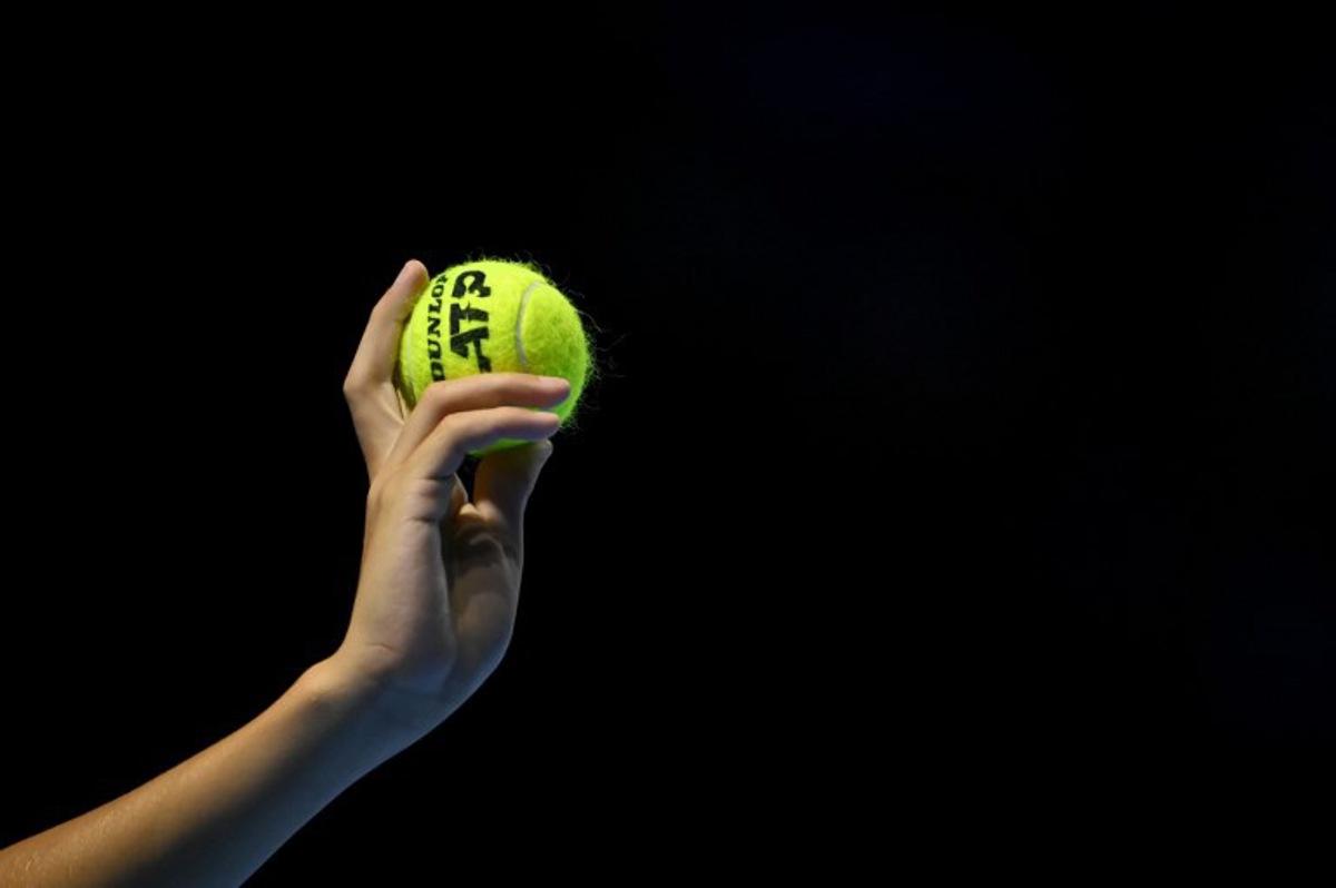 A ballboy hold up a tennis ball during a men's quarter final match at the Swiss Indoors ATP 500 tennis tournament in Basel on October 25, 2024. Fabrice COFFRINI / AFP