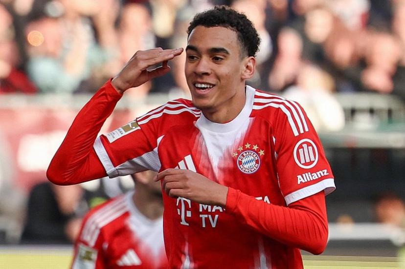 Bayern Munich's German midfielder #10 Jamal Musiala celebrates scoring the opening goal during the German first division Bundesliga football match between FC St Pauli and FC Bayern Munich in Hamburg, northern Germany, on April 11, 2026. Ibo OT / AFP