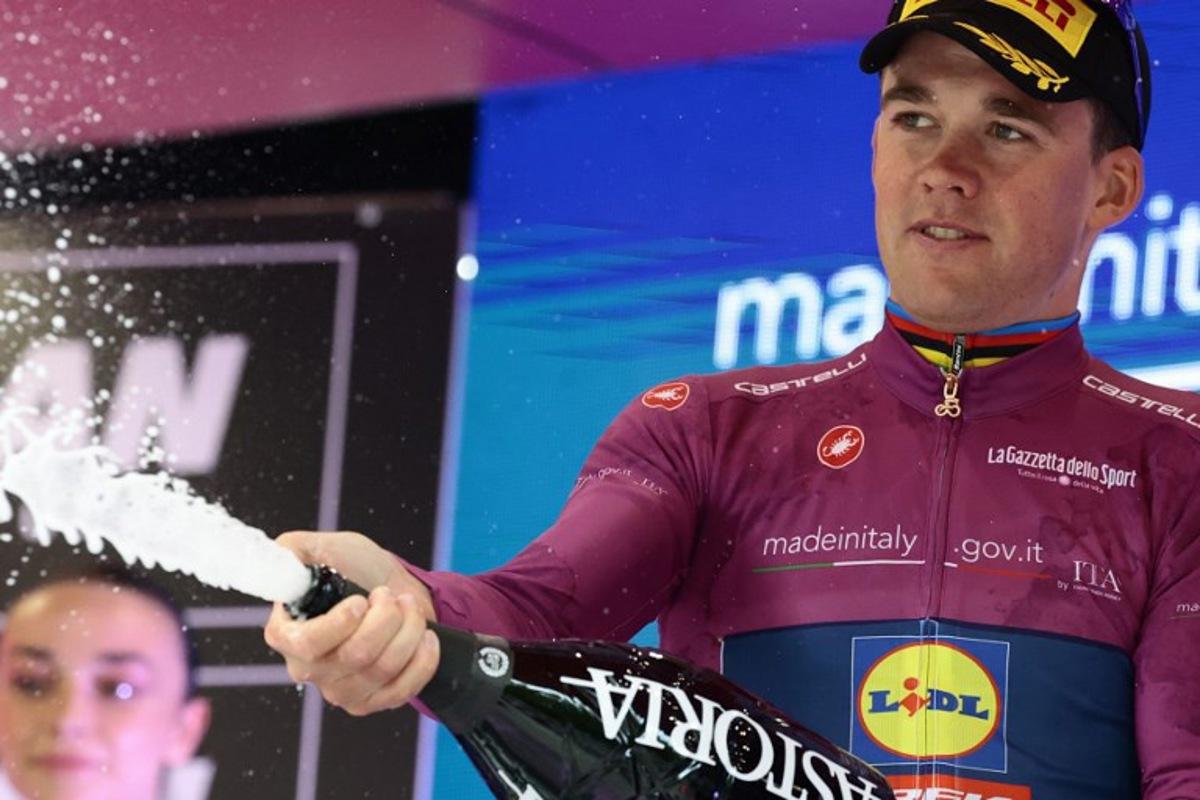 Lidl-Trek's Danish rider Mads Pedersen celebrates the Cyclamen Jersey on the podium of the 12th stage of the 108th Giro d'Italia cycling race of 172kms from Modena to Viadana on May 22, 2025. Luca Bettini / AFP