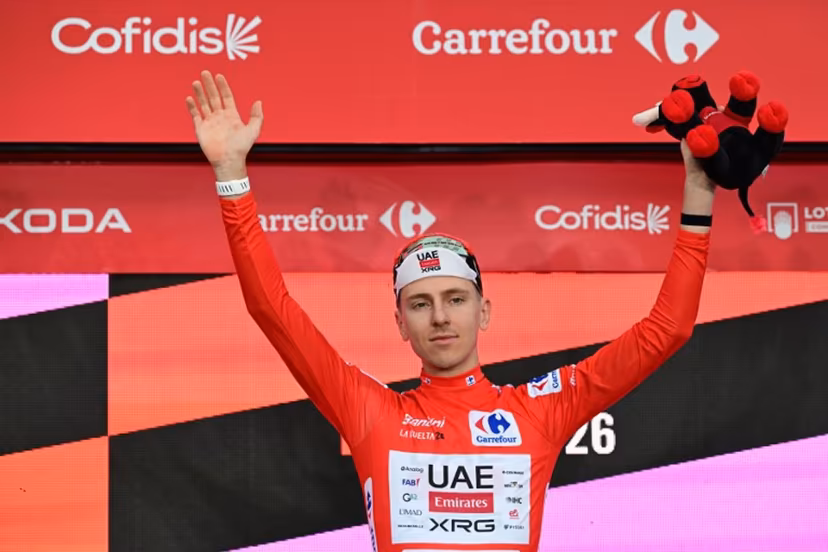 UAE Team Emirates - XRG team's Slovenian rider Tadej Pogacar celebrates on the podium wearing the overall leader's red jersey, after winning the first stage of the Vuelta a Espana 2026, a 9,4 km time-trial between Monaco and Monaco on August 22, 2026. Miguel MEDINA / AFP