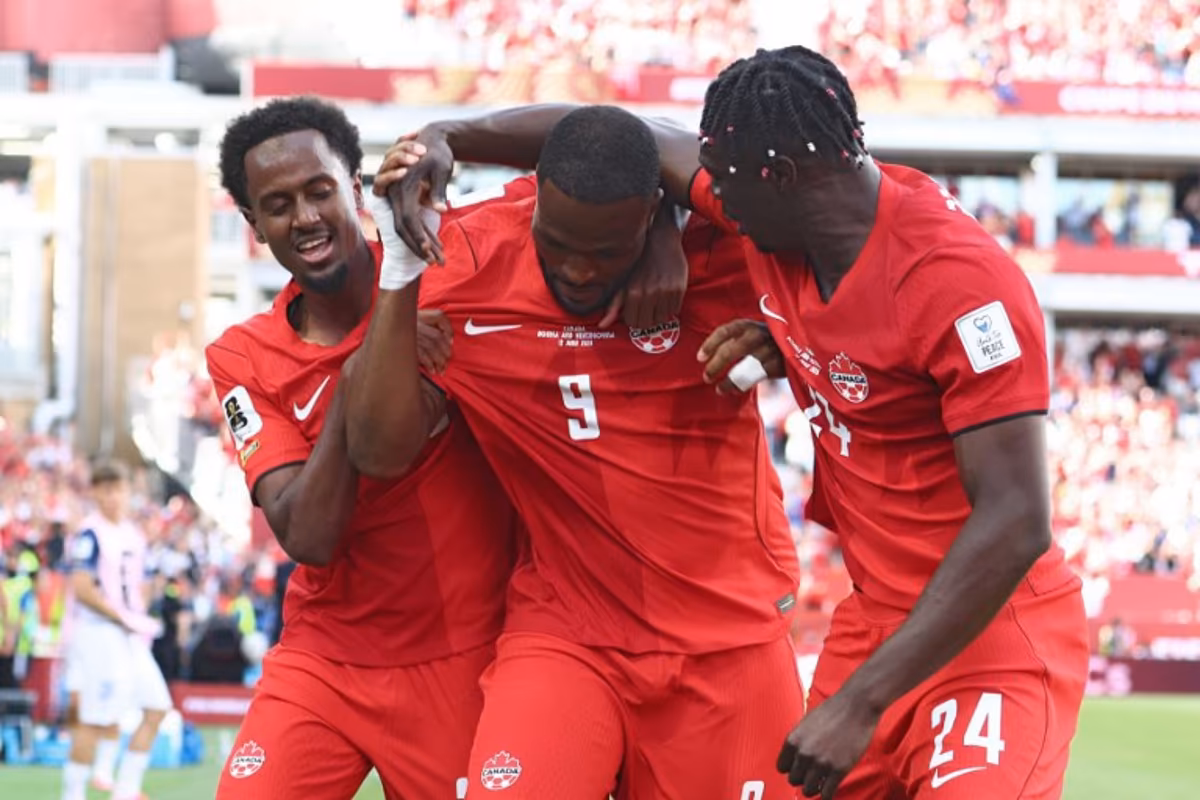 Canada's forward #09 Cyle Larin (C) is congratulated by teammates after scoring a goal during the 2026 World Cup Group B football match between Canada and Bosnia and Herzegovina at the Toronto Stadium in Toronto on June 12, 2026. Cole Burston / AFP