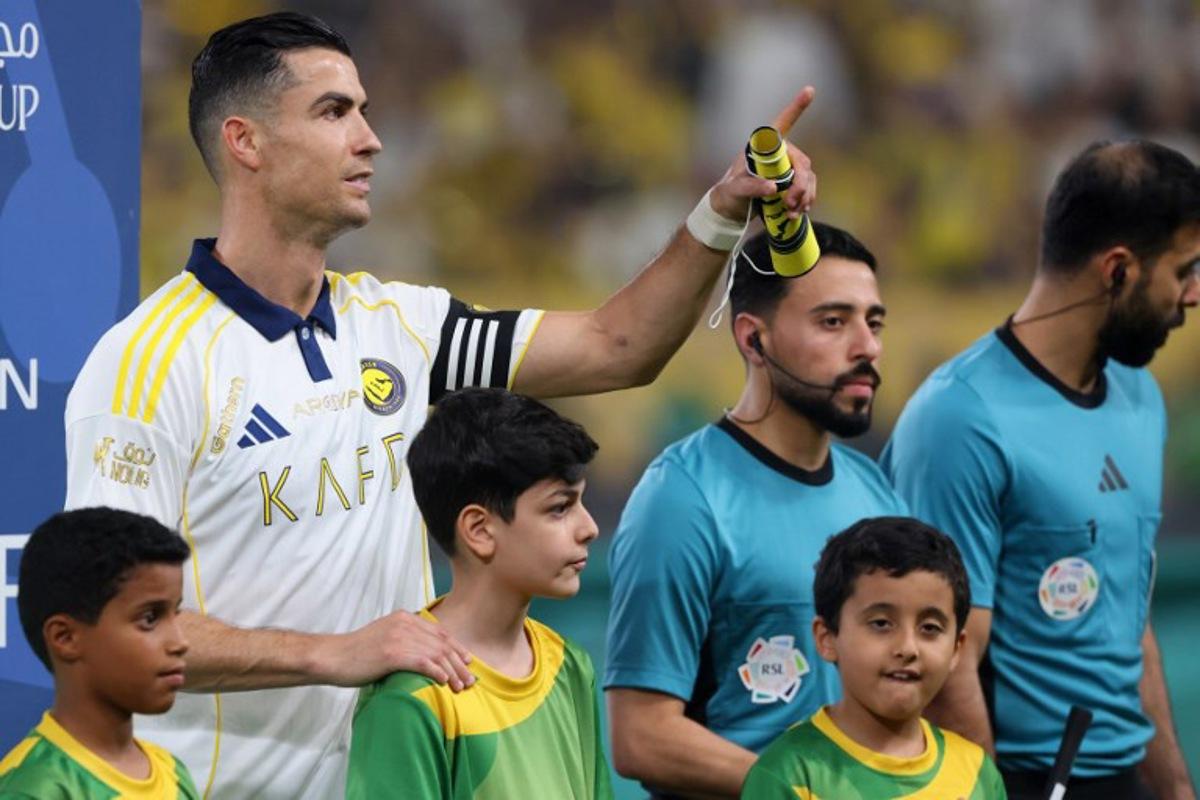 Nassr's Portuguese forward #07 Cristiano Ronaldo gestures to spectators before the start of the Saudi Pro League football match between Al-Nassr and Damac at the Al-Awwal Park Stadium in Riyadh on May 21, 2026. Fayez NURELDINE / AFP
