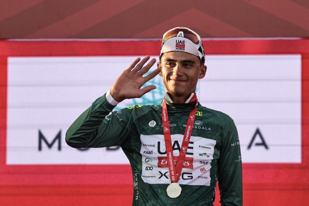 UAE Team Emirates's Mexican rider Isaac Del Toro Romero wears the green jersey as he celebrates on the podium at the end of the third stage of the UAE Tour cycling event from Umm al-Quwain to Jebel Mobrah in Ras al-Khaimah on February 18, 2026. Fadel SENNA / AFP