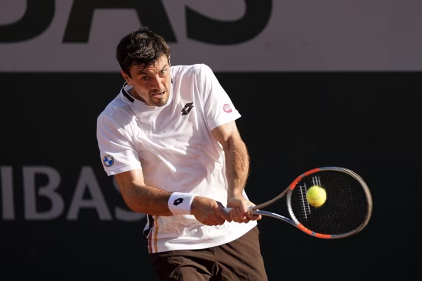 Austria's Sebastian Ofner plays a backhand return to Italy's Luciano Darderi during their men's singles match on day 3 of the French Open tennis tournament at the Roland-Garros Complex in Paris on May 26, 2026. Dimitar DILKOFF / AFP