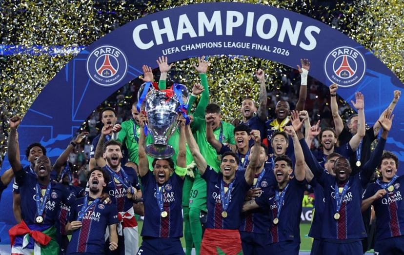 Paris Saint-Germain's Brazilian defender #05 Marquinhos lifts the trophy as he celebrates with teammates after winning the UEFA Champions League final football match between Paris Saint-Germain (PSG) and Arsenal FC at the Puskas Arena in Budapest on May 30, 2026. FRANCK FIFE / AFP