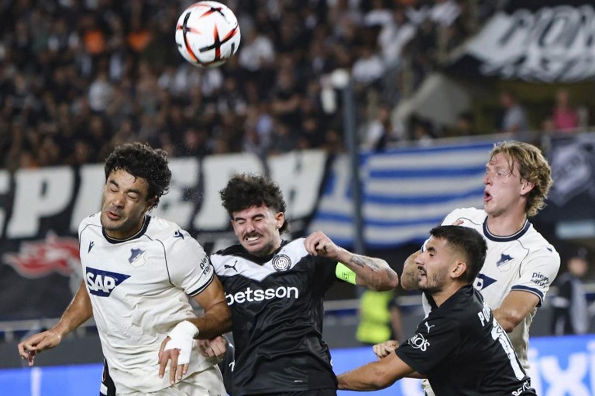 Hoffenheim's Turkish defender #5 Ozan Kabak (L) fights for the ball with OFI's Greek midfielder #14 Thanasis Androutsos (C) and Greek defender #15 Achilleas Poungouras during the UEFA Europa League first round football match between OFI Crete FC and TSG 1899 Hoffenheim at Pankritio stadium in Heraklion on September 17, 2026. Costas Metaxakis / AFP