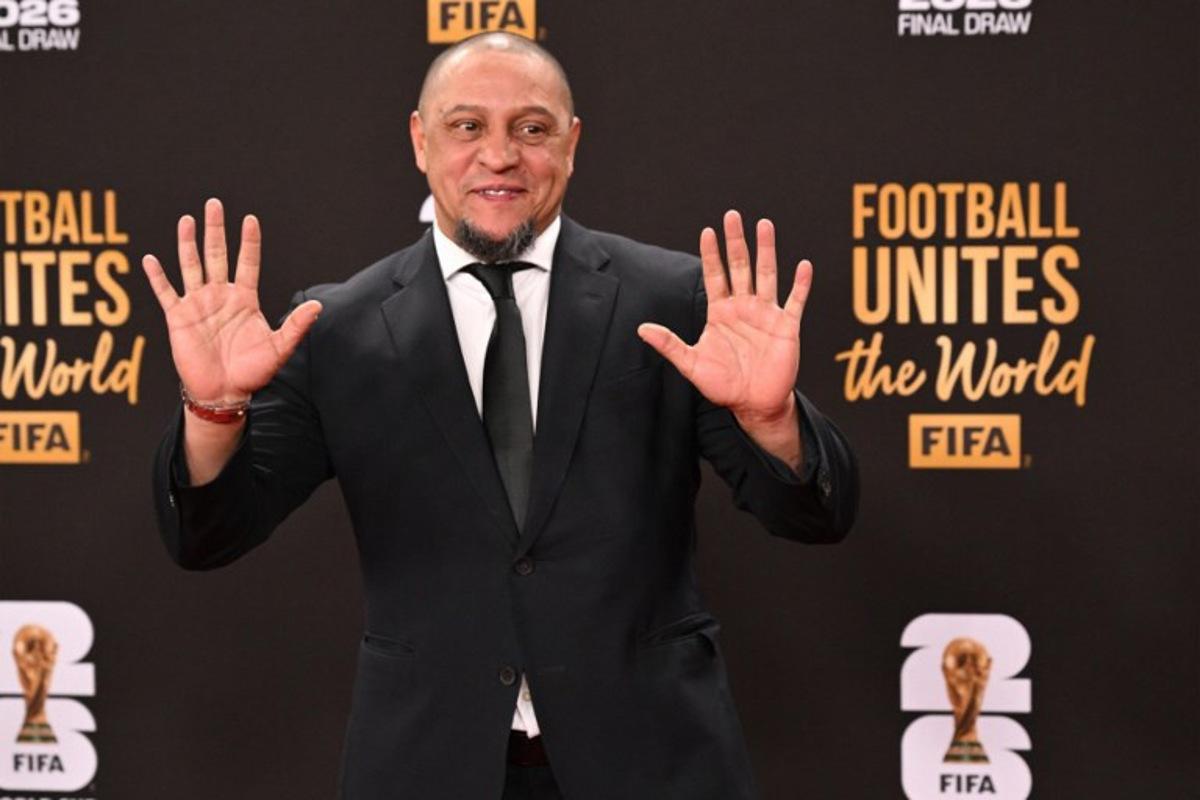 Former Brazilian soccer player Roberto Carlos poses on the red carpet upon arrival to attend the draw for the 2026 FIFA Football World Cup taking place in the US, Canada and Mexico, at the Kennedy Center, in Washington, DC, on December 5, 2025. Roberto SCHMIDT / AFP