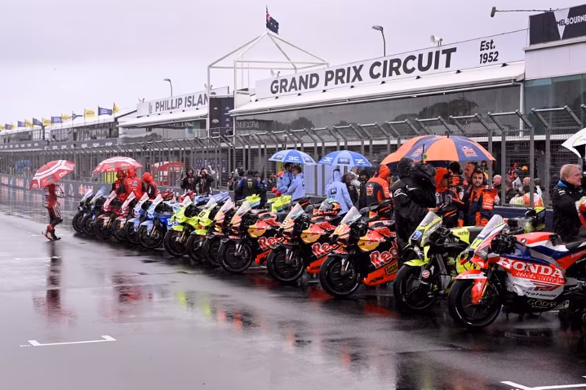 MotoGP bikes are seen lined up after a farewell lap following the cancellation of the last Australian MotoGP Grand Prix to be held at Phillip Island on October 25, 2026, due to inclement weather conditions. Organisers pulled the plug despite a sell-out crowd with persistent rain and poor visibility making racing unsafe. The Moto3 and Moto2 races were also called off. William WEST / AFP