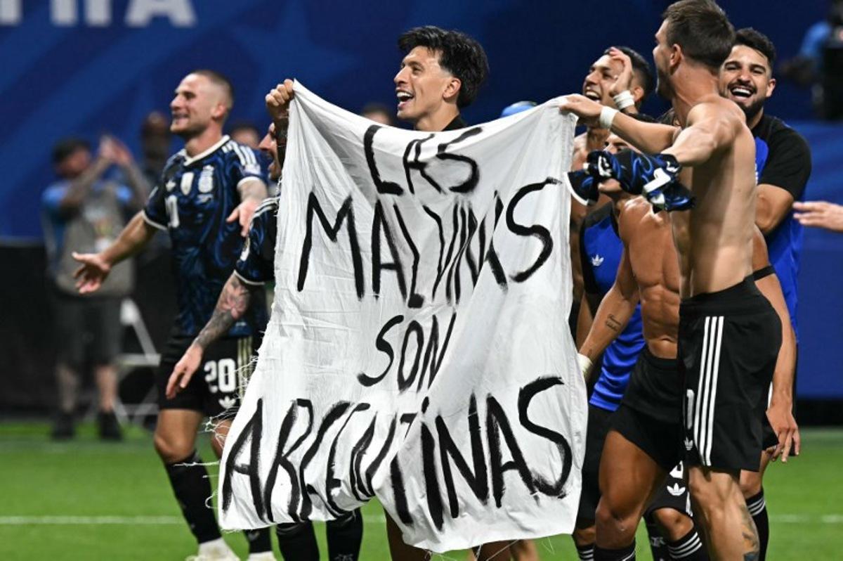 Argentina's players hold a banner reading "The Malvinas (Falkland Islands) belong to Argentina," after winning the 2026 World Cup football tournament semi-final match between England and Argentina at the Atlanta Stadium in Atlanta on July 15, 2026. Paul ELLIS / AFP