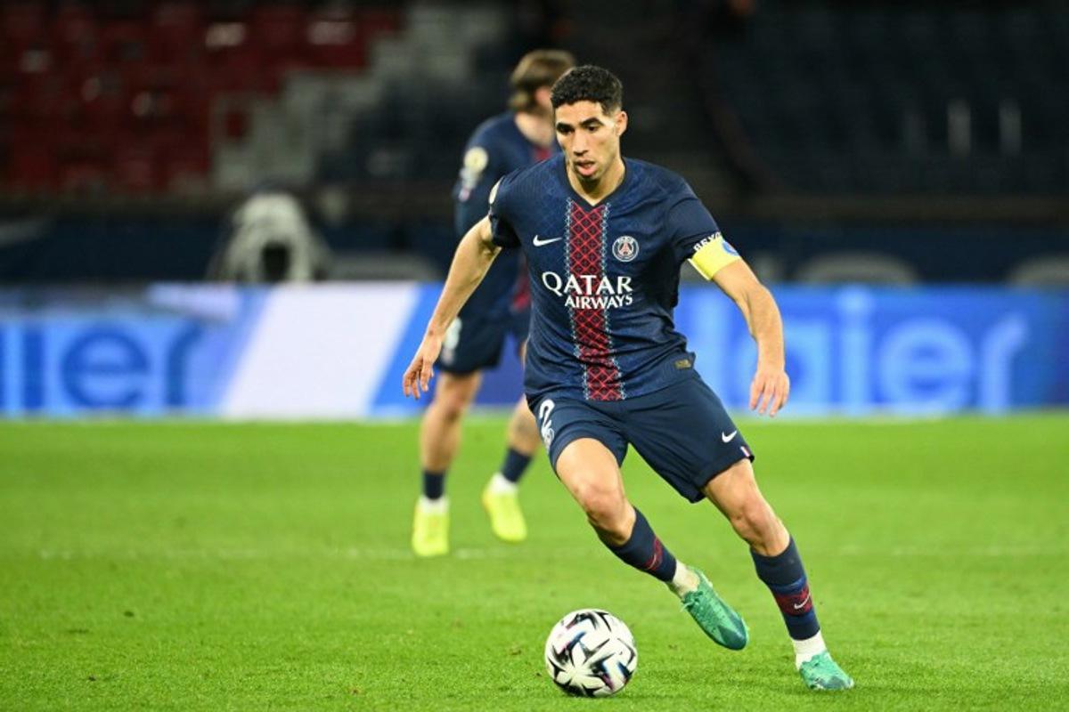 Paris Saint-Germain's Moroccan defender #02 Achraf Hakimi runs with the ball during the French L1 football match between Paris Saint-Germain (PSG) and FC Metz at the Parc des Princes stadium in Paris on February 21, 2026. Bertrand GUAY / AFP