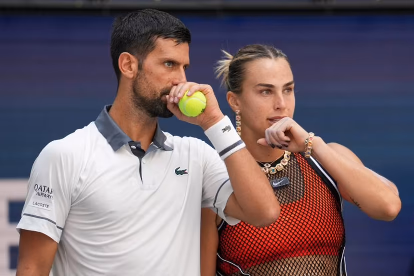 Serbia's Novak Djokovic (L) and Belarus's Aryna Sabalenka (R) speak with each other during their mixed doubles tennis match against Czech Republic's Katerina Siniakova and Britain's Henry Patten during Fan Week as part of the 2026 US Open tennis tournament at the USTA Billie Jean King National Tennis Center in New York, on August 25, 2026. TIMOTHY A. CLARY / AFP