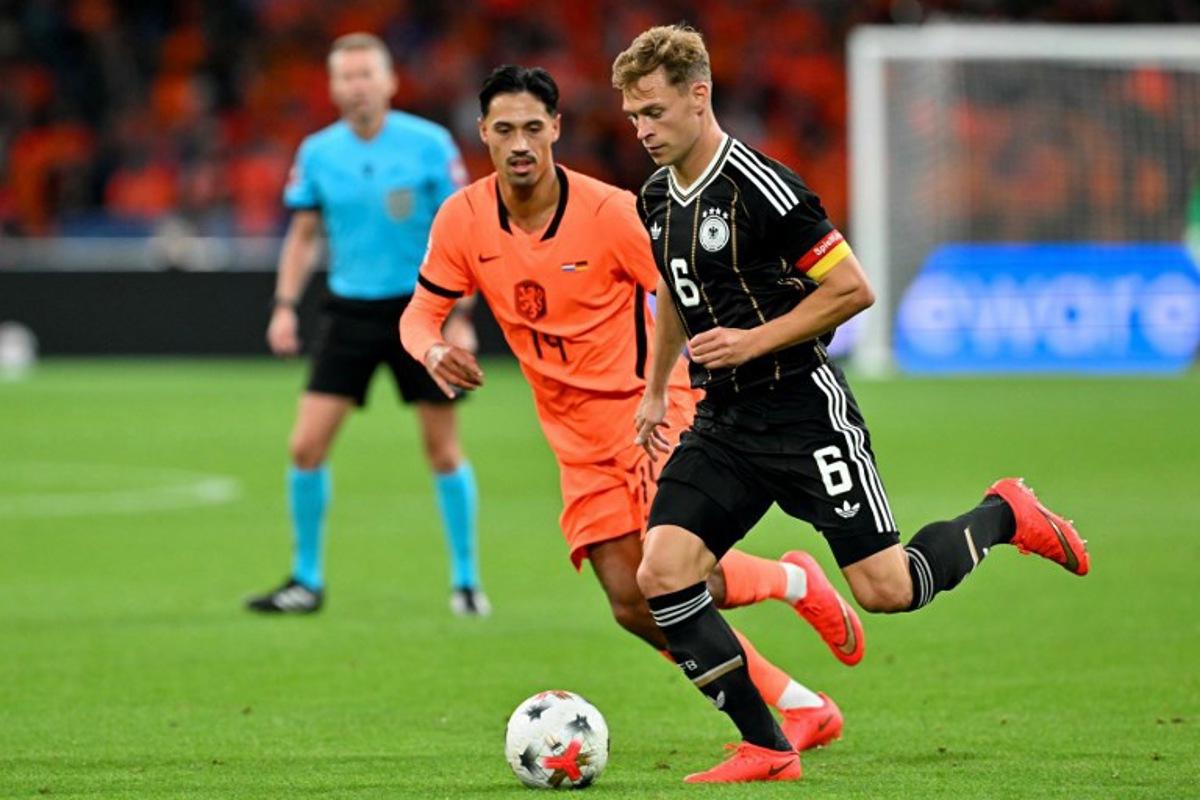 Netherlands' midfielder #14 Tijjani Reijnders (L) fights for the ball with Germany's midfielder #06 Joshua Kimmich during the UEFA Nations League (League A, Group A2) football match between Netherlands and Germany at Johan Cruijff ArenA in Amsterdam on September 24, 2026. NICOLAS TUCAT / AFP