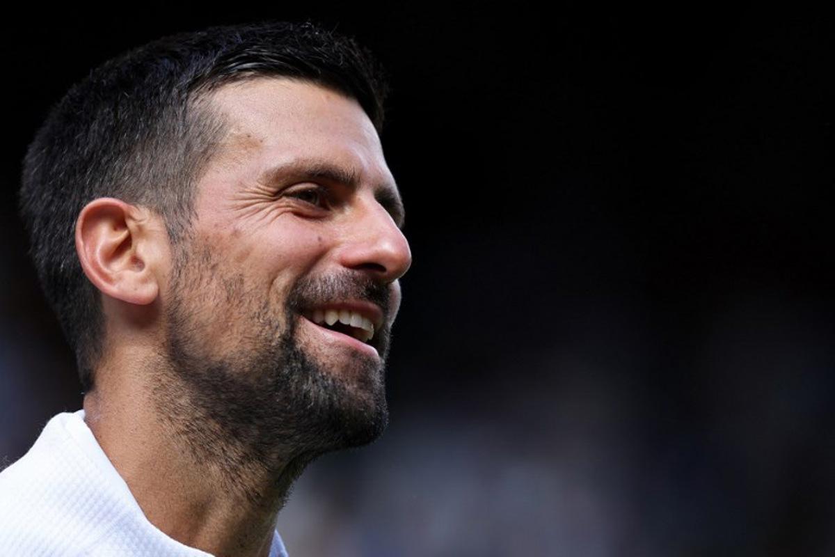 Serbia's Novak Djokovic speaks to the audience after winning his men's singles second round tennis match against Britain's Daniel Evans on the fourth day of the 2025 Wimbledon Championships at The All England Lawn Tennis and Croquet Club in Wimbledon, southwest London, on July 3, 2025. Adrian Dennis / AFP