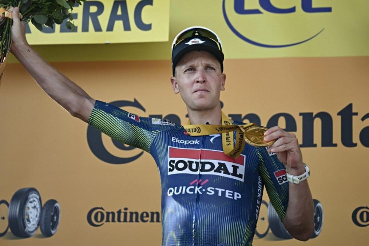Soudal Quick-Step team's Belgian rider Tim Merlier celebrates on the podium after winning the 8th stage of the 113th edition of the Tour de France cycling race, 182 km between Périgueux and Bergerac in southwestern France, on July 11, 2026. Loic VENANCE / AFP
