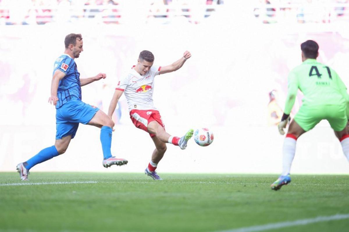 Leipzig's Austrian midfielder #14 Christoph Baumgartner (C) scores the opening goal past Heidenheim's German goalkeeper #41 Diant Ramaj (R) during the German first division Bundesliga football match between RB Leipzig and 1. FC Heidenheim 1846 in Leipzig on August 30, 2025. Ronny HARTMANN / AFP