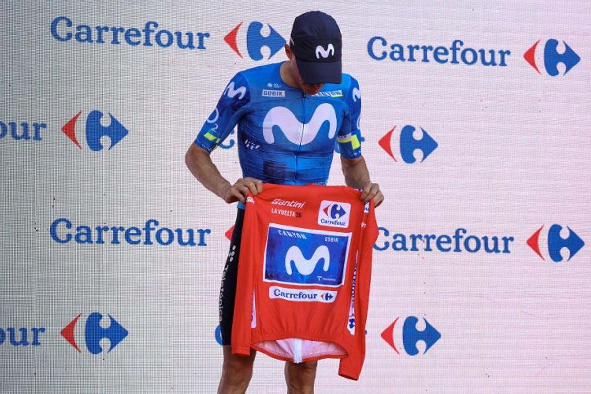 New overall race leader Team Movistar's Spanish rider Enric Mas holds the race leader's red jerse without wearing it on the podium after the eighth stage of the Vuelta a Espana 2026, a 171 km race between Pucol and Xeraco on August 29, 2026. Previous race leader Tadej Pogacar pulled out of the Vuelta a Espana on Saturday after a heavy fall 31km from the finish of a flat stage eight left him with shoulder and face injuries. Pogacar of Team UAE has won five Tour de France titles and a Giro d'Italia and was targetig his first overall victory on the Spanish 21-day race. Josep LAGO / AFP
