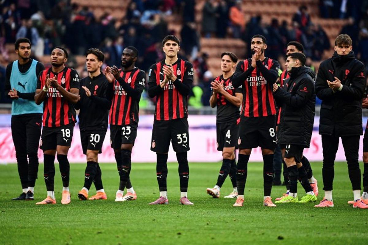 AC Milan players acknowledge their supporters at the end of the Italian Serie A football match between AC Milan and Sassuolo at the San Siro Stadium in Milan on December 14, 2025. Piero CRUCIATTI / AFP