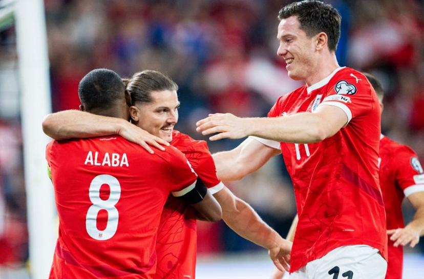 Austria's forward #09 Marcel Sabitzer (Back) celebrates his 1-0 from a penalty kick with Austria's defender #08 David Alaba (L) and Austria's forward #11 Michael Gregoritsch during the 2026 World Cup qualifiers Europe zone group H football match between Austria and Cyprus, on September 6, 2025 in Linz, Austria. GEORG HOCHMUTH / APA / AFP
