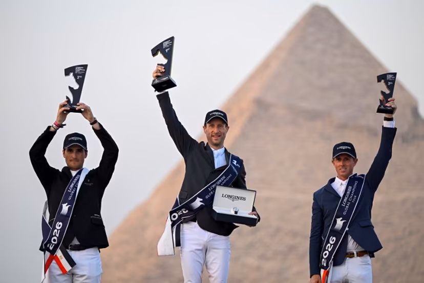 Belgium's first-place winner Pieter Devos (C), second-place winner Olivier Philippaerts (L), and England's third-place winner Ben Maher celebrate on the podium after the Longines Global Champions Tour 2026 at the Giza pyramids, west of Cairo on October 24, 2026. Khaled DESOUKI / AFP