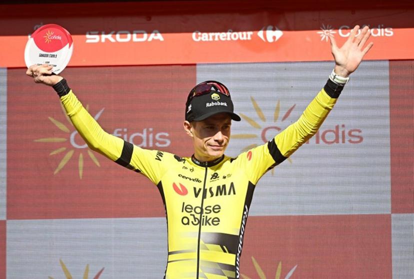 Team Visma-Lease a bike's Danish rider Jonas Vingegaard celebrates on stage after winning the 9th stage of the Vuelta a Espana, a 195 km race between Alfaro and Valdezcaray, on August 31, 2025. ANDER GILLENEA / AFP