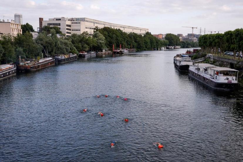 A group of swimmers enjoy the River Seine in Ile-Saint-Denis, north of Paris on July 2, 2023. It is still prohibited to swim in the river Seine, but a year before the Olympic Games, which should inaugurate the reunion between this practice and the river, a group of pioneer swimmers fears neither the pollution, nor the Police. Geoffroy Van der Hasselt / AFP