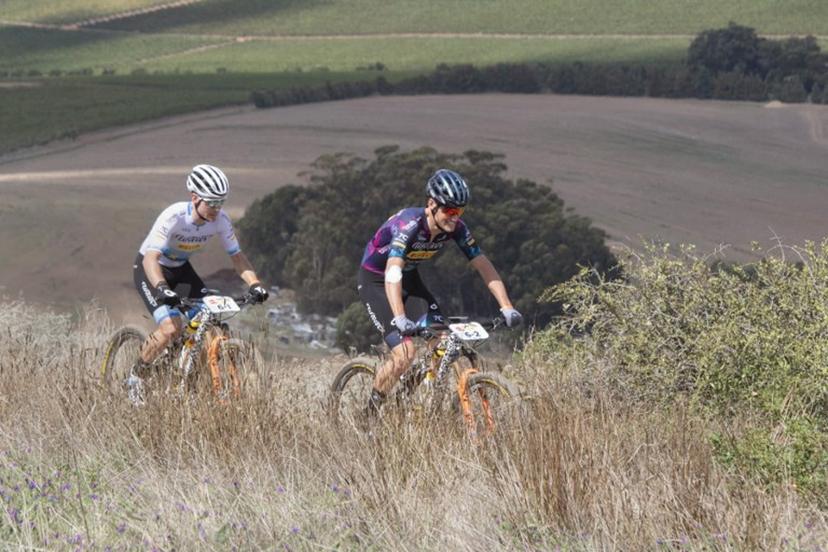 Fabian Rabensteiner (R) and teammate, Wout Alleman, ride during the prologue stage of the 2023 Cape Epic mountain bike stage race, in Durbanville, near Cape Town on March 19, 2023. The Cape Epic, in which two riders race as a team, is widely known as one of the foremost mountain bike stage race in the world, with the riders from all around the world covering a distance of approximately 700 kilometres, and gaining over 16000m in height, over eight days of racing. RODGER BOSCH / AFP