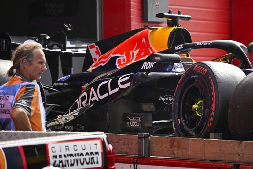 An employee stands next to the crashed car of Red Bull Racing's Dutch driver Max Verstappen during the Formula One Dutch Grand Prix at The Circuit Zandvoort, western Netherlands, on August 23, 2026. JOHN THYS / AFP
