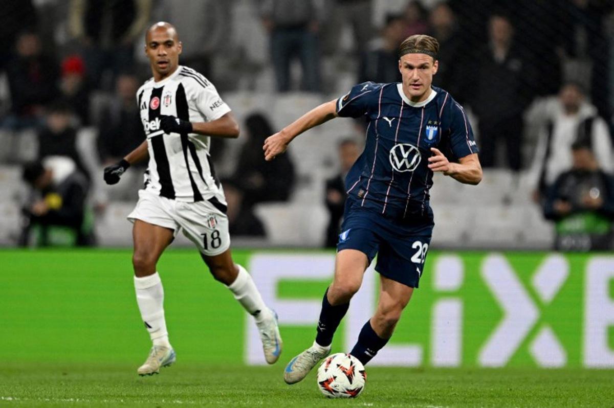 Malmo's Lasse Berg Johnsen (R) fights for the ball with Besiktas' Joao Mário (L) during the UEFA Europa League league phase day 4 football match between Besiktas JK and Malmö at the Besiktas Park Stadium in Istanbul on November 6, 2024. Ozan KOSE / AFP