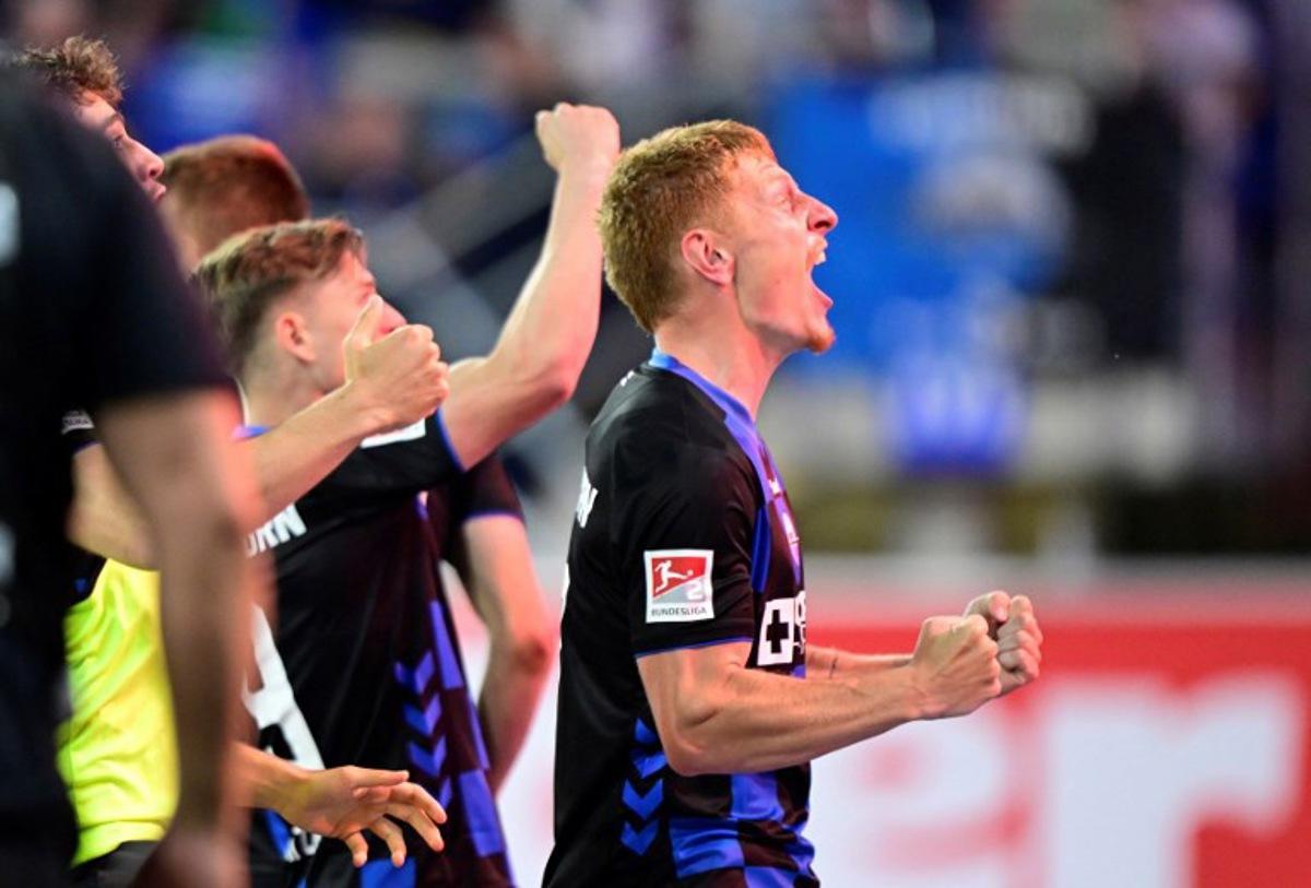 SC Paderborn's German defender #17 Laurin Curda (R) celebrates his 2-1 during the German Bundesliga relegation second-leg football match between SC Paderborn 07 and VfL Wolfsburg in Heidenheim on May 22, 2025. Ina FASSBENDER / AFP