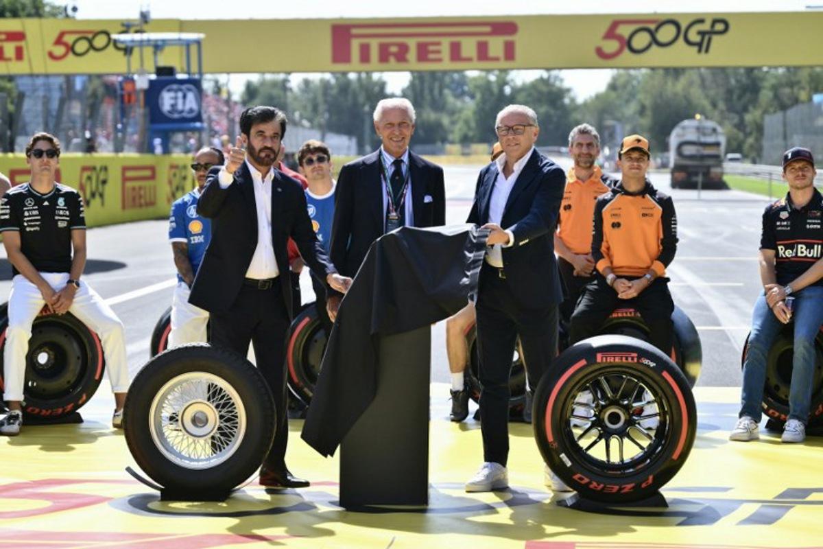 FIA president Mohammed Ben Sulayem (L), Pirelli CEO Marco Tronchetti Provera (C) and F1 CEO Stefano Domenicali (R) celebrate the 500th Grand Prix for Pirelli, as they attend the drivers' parade prior to the Italian Formula One Grand Prix at the Autodromo Nazionale Monza circuit, in Monza, northern Italy, on September 7, 2025. Marco BERTORELLO / AFP