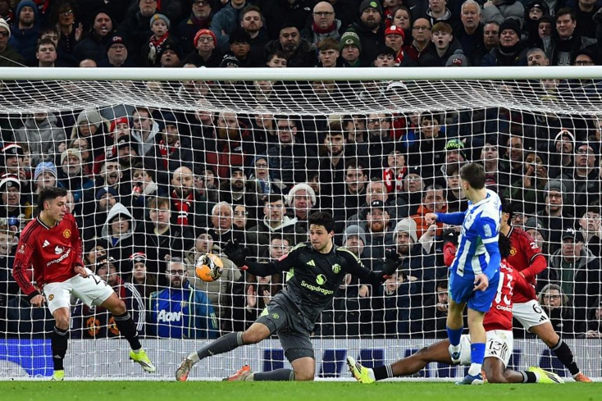 Brighton's German midfielder #08 Brajan Gruda (R) scores the opening goal during the English FA Cup third round football match between Manchester United and Brighton and Hove Albion at Old Trafford Stadium in Manchester, north west England, on January 11, 2026. PETER POWELL / AFP
