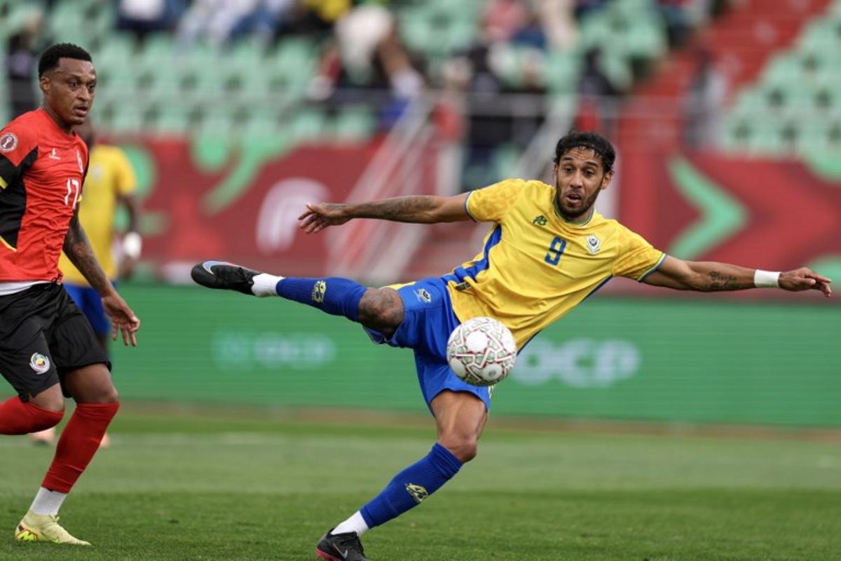 Mozambique's defender #17 Edson Sitoe and Gabon's forward #09 Pierre-Emerick Aubameyang vie during the Africa Cup of Nations (CAN) Group F football match between Gabon and Mozambique at Grand Stadium in Agadir on December 28, 2025. FRANCK FIFE / AFP