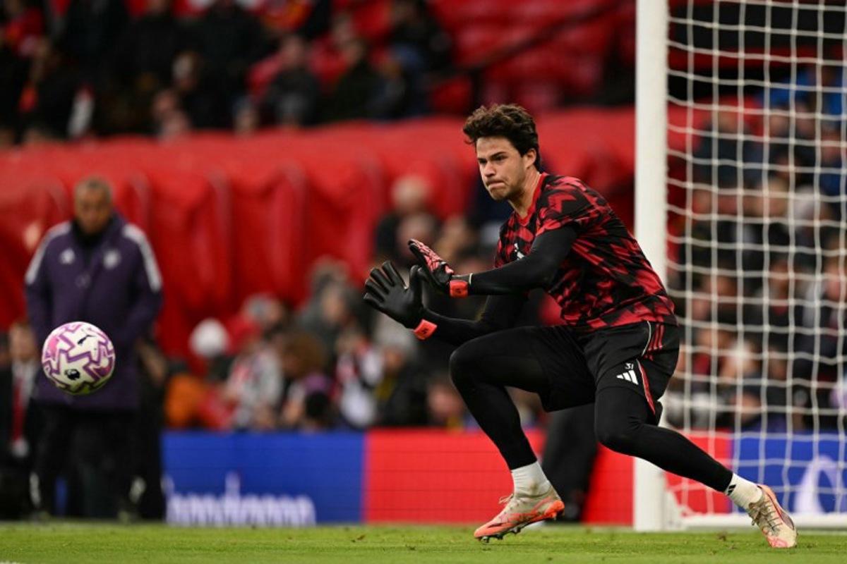 Manchester United's Belgian goalkeeper #31 Senne Lammens warms up for the English Premier League football match between Manchester United and Brighton and Hove Albion at Old Trafford in Manchester, north west England, on October 25, 2025. Oli SCARFF / AFP