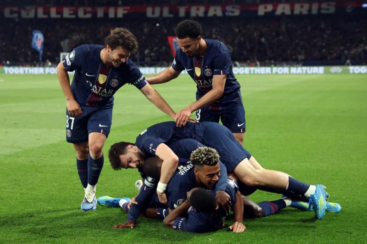 Paris Saint-Germain's French forward #10 Ousmane Dembele (down) celebrates with Paris Saint-Germain's French midfielder #14 Desire Doue, Paris Saint-Germain's Georgian forward #07 Khvicha Kvaratskhelia and Paris Saint-Germain's Portuguese defender #25 Nuno Mendes, Paris Saint-Germain's Portuguese midfielder #87 Joao Neves and Paris Saint-Germain's French midfielder #33 Warren Zaire-Emery after scoring his team fifth goal during the UEFA Champions League semi-final first leg football match between Paris Saint-Germain (PSG) and Bayern Munich at the Parc des Princes in Paris on April 28, 2026. Alain JOCARD / AFP