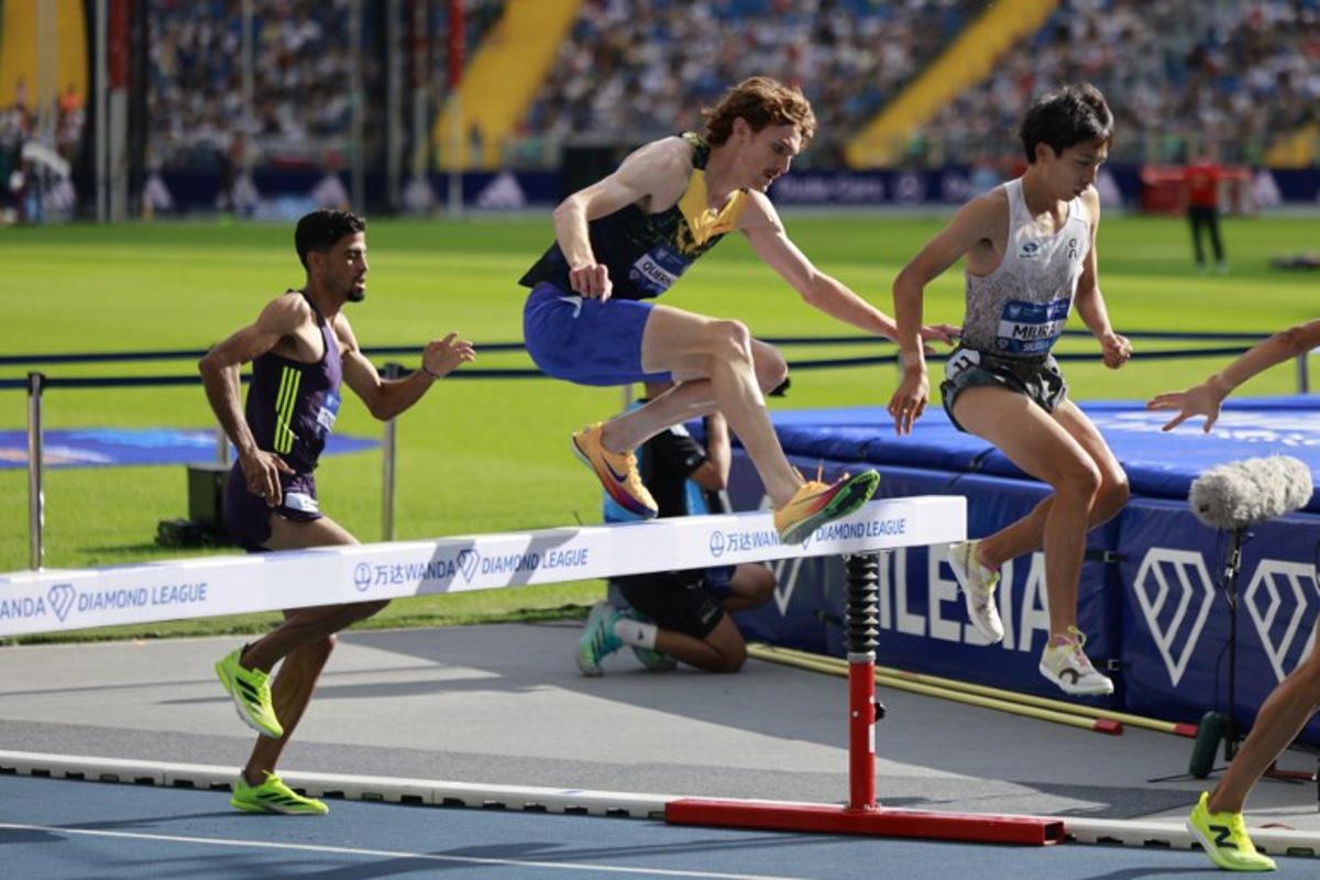 Japan's Ryuji Miura (R), Luxembourg's Ruben Querinjean (C) and Marocco's Mohamed Tindouft (L) compete in the 3000 m Steeple Chase competition of the Silesia Diamond League athletics meeting in Katowice, Poland, on August 23, 2026. Wojtek RADWANSKI / AFP
